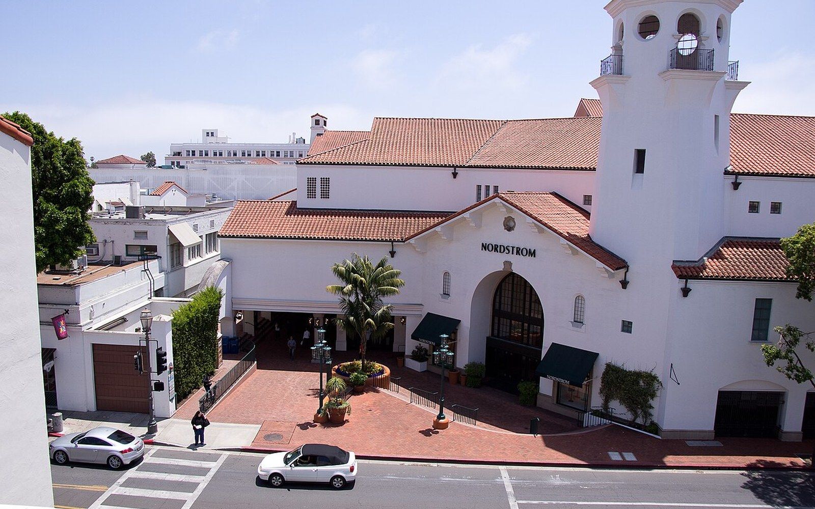 An upper shopping arcade with white stucco piers